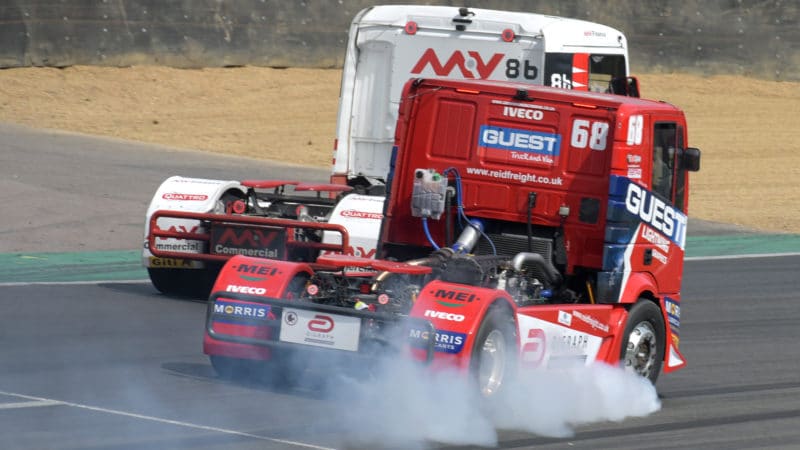 Racing truck of Craig Reid locks up in a cloud of smoke