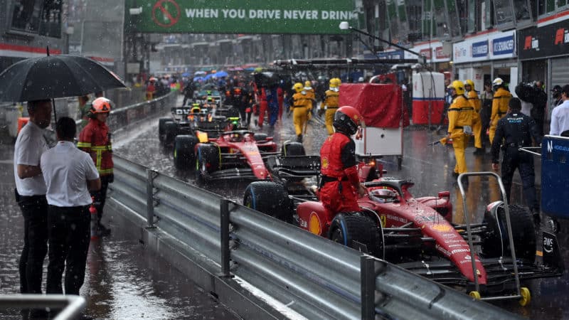 Rain falls at the 2022 Monaco Grand Prix as the cars line up in the pitlane
