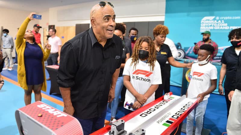 FORT LAUDERDALE, FL - APRIL 07: Willy T Ribbs, retired American race car driver, reacts as he participates in a race car game with students under the F1 in Schools program during the Formula 1 Crypto.com Miami Grand Prix press conference at Bunche Park, Miami Gardens on April 7, 2022 in Fort Lauderdale, United States. Ribbs, along with event organizers, surprised students under the F1 in Schools program with tickets to the inaugural event. (Photo by Johnny Louis/Getty Images)