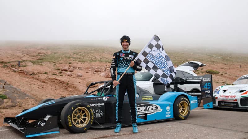 Robin Shute at summit of Pikes Peak with king of the mountain flag
