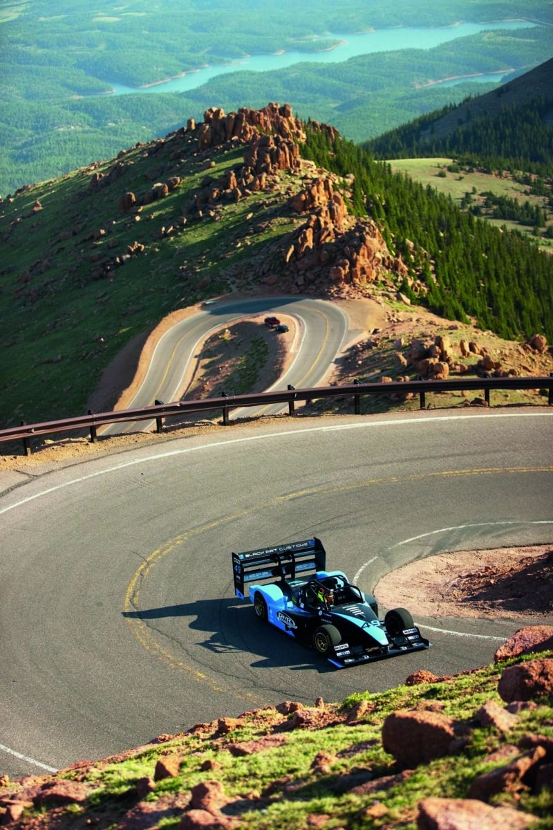 Robin Shute on Pikes PEak in his Wolf with twisting road in background
