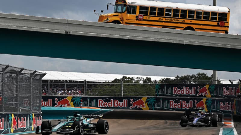 School bus drives on bridge over F1 cars at the 2022 Miami Grand Prix