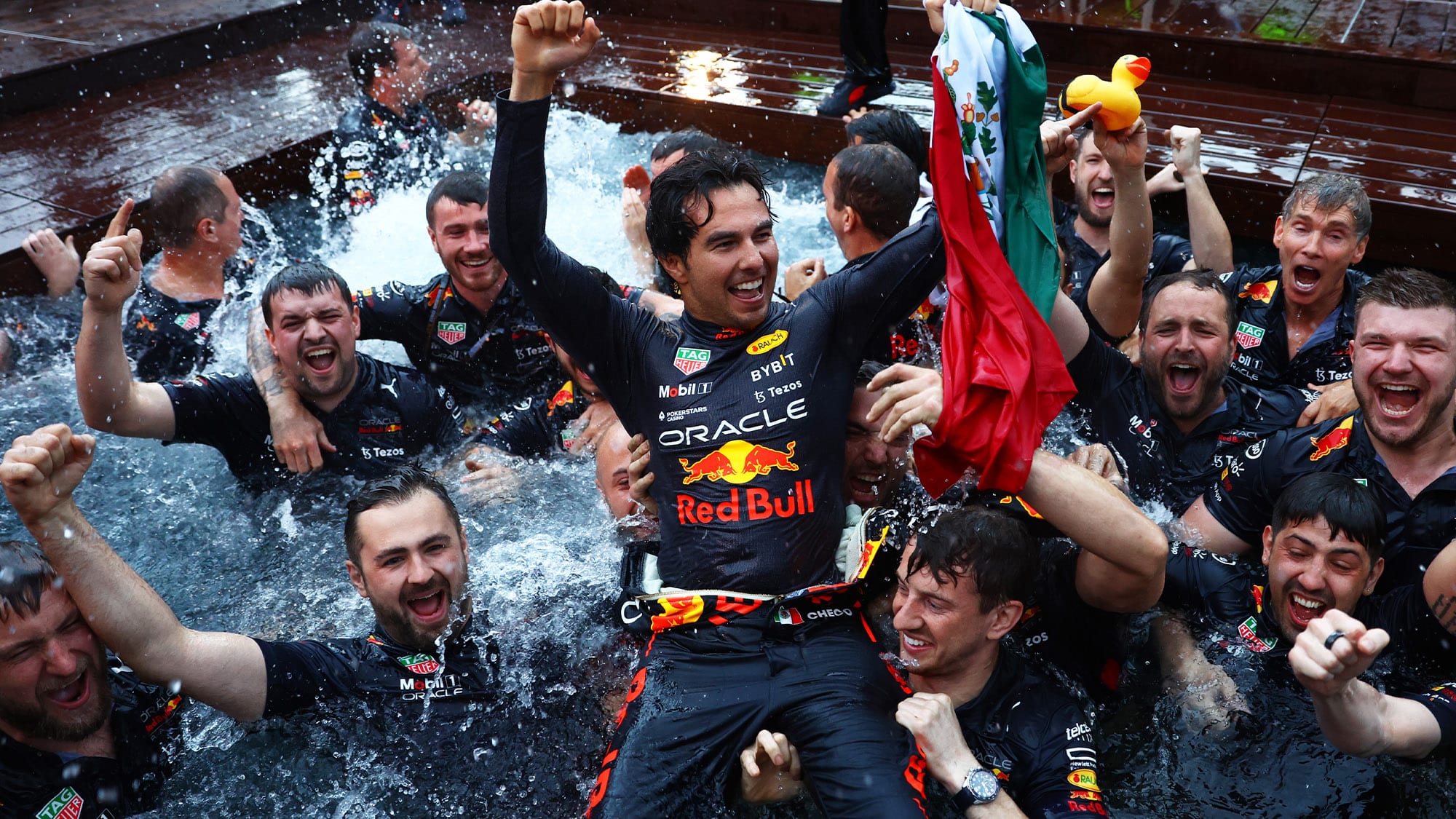 Sergio Perez celebrates with crew in the Red Bull pool after winning 2022 Monaco Grand Prix