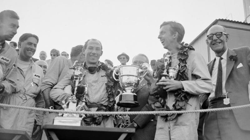 13th September 1958: Stirling Moss (left) and co-driver Tony Brooks with the trophy after winning the Tourist Trophy Sports Car Race at Goodwood. (Photo by Keystone/Getty Images)