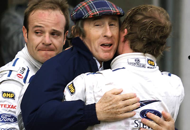 Jackie Stewart, Johnny Herbert and Rubens Barrichello rues his tyre error in the background