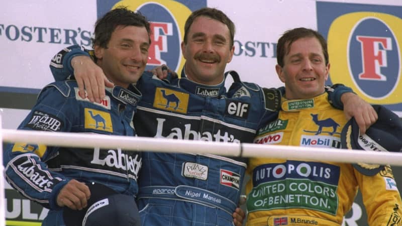 1992: Williams Renault drivers Riccardo Patrese (left) of Italy and Nigel Mansell (centre) of Great Britain stand on the winners'' podium with Benetton Ford driver Martin Brundle also of Great Britain after the British Grand Prix at the Silverstone circuit in England. Mansell finished in first place, Patrese in second and Brundle in third. \ Mandatory Credit: Mike Hewitt/Allsport