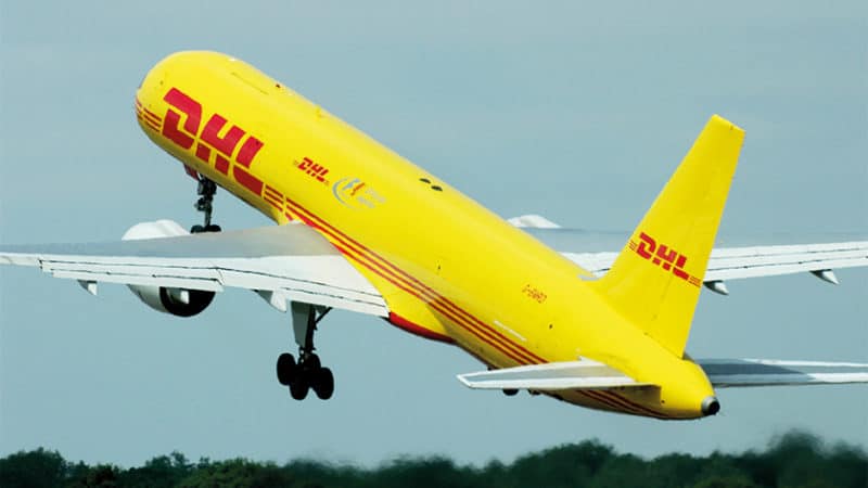 DHL Air Boeing 757 G-BMRD cargo transport jet plane taking off at an airshow. Boeing 757-200. Yellow scheme with F1 Official Logistics. Space for copy