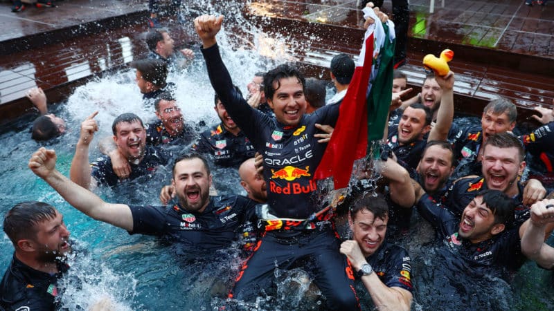 MONTE-CARLO, MONACO - MAY 29: Race winner Sergio Perez of Mexico and Oracle Red Bull Racing celebrates with his team by jumping into the pool after the F1 Grand Prix of Monaco at Circuit de Monaco on May 29, 2022 in Monte-Carlo, Monaco. (Photo by Mark Thompson/Getty Images)