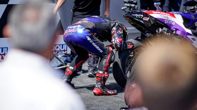 Fabio Quartararo kisses the rear Michelin tyre on his Yamaha at the 2022 MotoGP German GP
