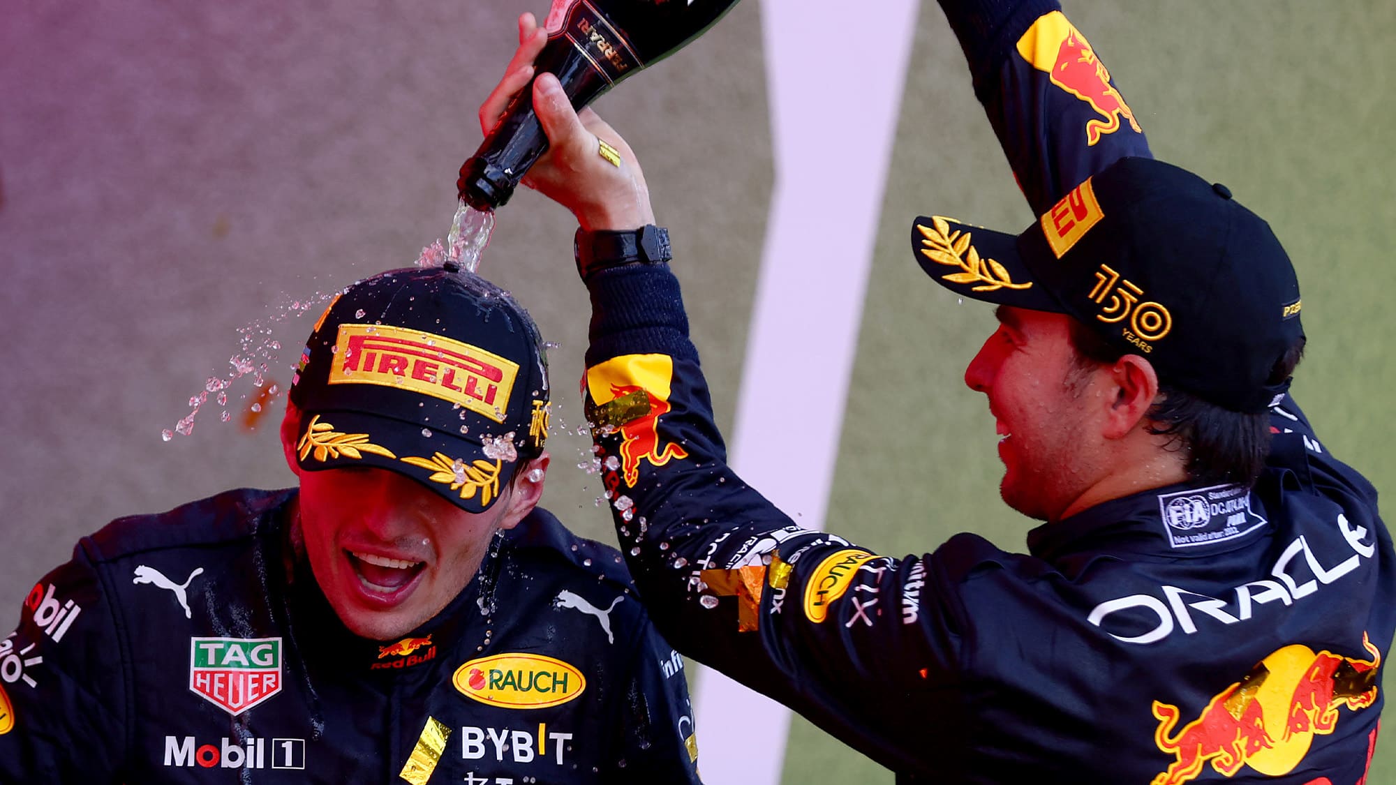 Sergio Perez pours champagne over Max Verstappen after the 2022 Azerbaijan GP