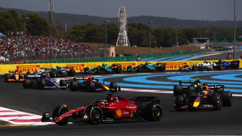 LE CASTELLET, FRANCE - JULY 24: Charles Leclerc of Monaco driving the (16) Ferrari F1-75 leads Max Verstappen of the Netherlands driving the (1) Oracle Red Bull Racing RB18 and the rest of the field on lap one during the F1 Grand Prix of France at Circuit Paul Ricard on July 24, 2022 in Le Castellet, France. (Photo by Joe Portlock - Formula 1/Formula 1 via Getty Images)