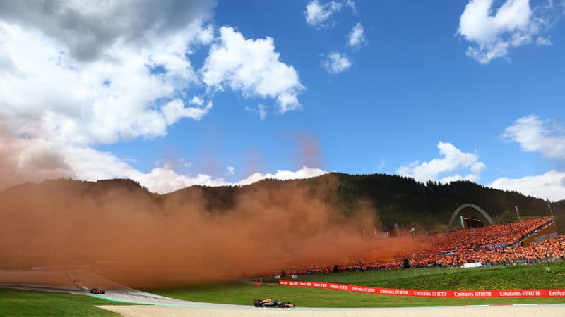 Orange smoke from Max Verstappen fans in the crowd at the 2022 Austrian GP
