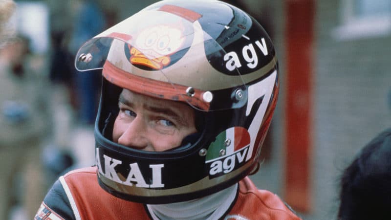 Barry Sheene glances at the camera while wearing a crash helmet