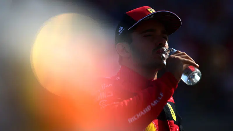 Charles Leclerc drinks from a water bottle at the 2022 French Grand Prix