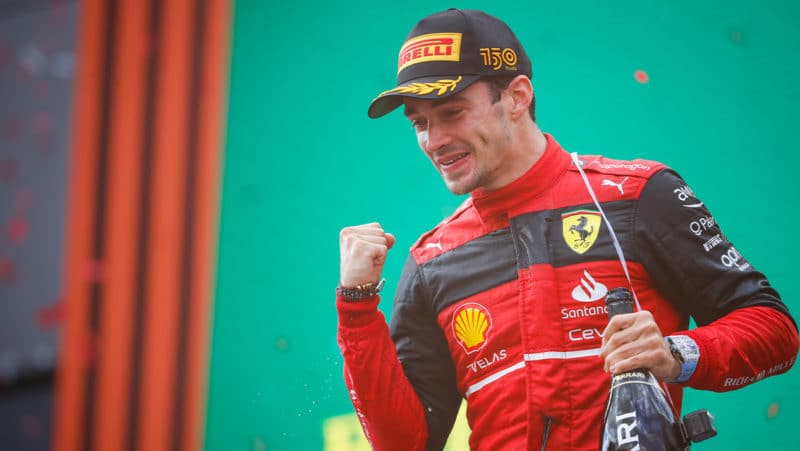 Charles Leclerc pumps his fist on the podium at the 2022 Austrian Grand Prix