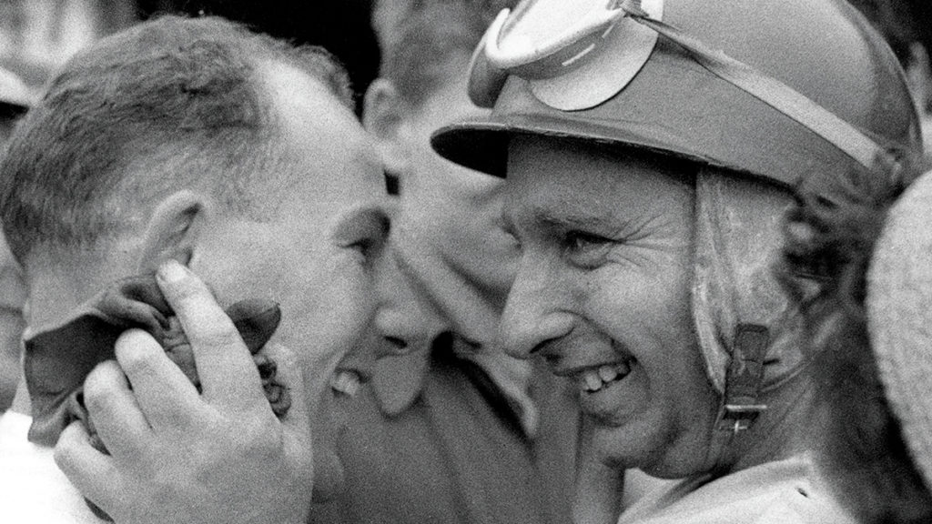 Fangio congratulates Stirling Moss after his 1955