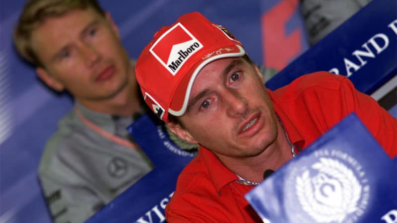 Ferrari F1 driver Eddie Irvine at a press conference in 1999