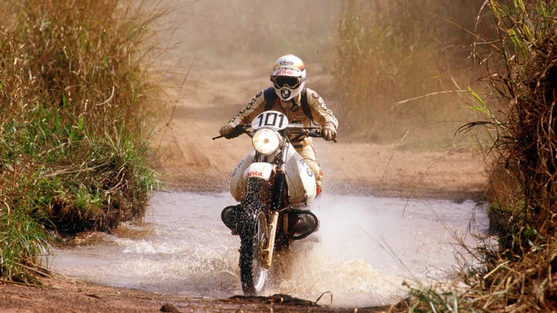 Gaston Rahier drives through a water-filled ditch in the 1984 Paris-Dakar