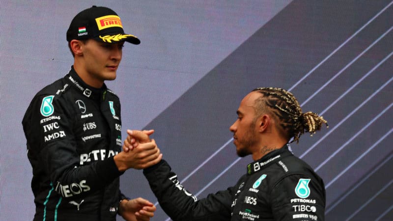 George Russell shakes hands with Lewis Hamilton on the podium after the 2022 Hungarian Grand Prix