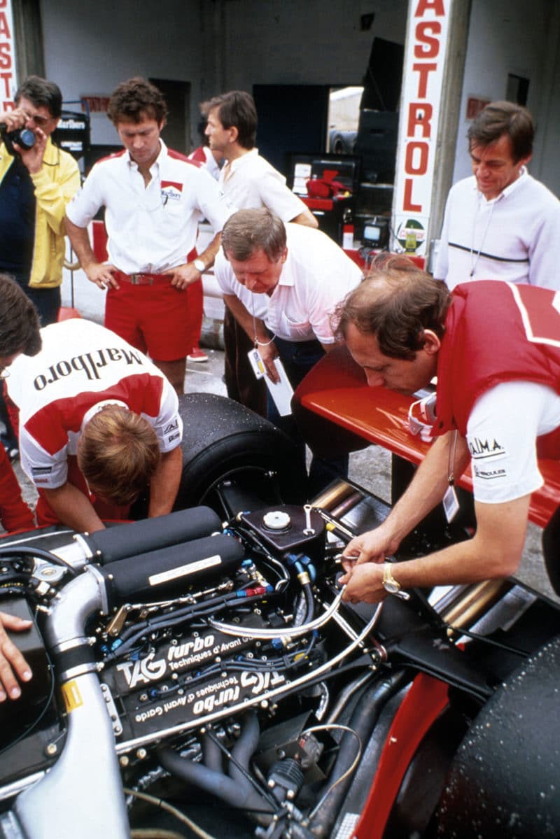 McLaren team work on TAG V6 turbo engine at the 1983 Italian GP