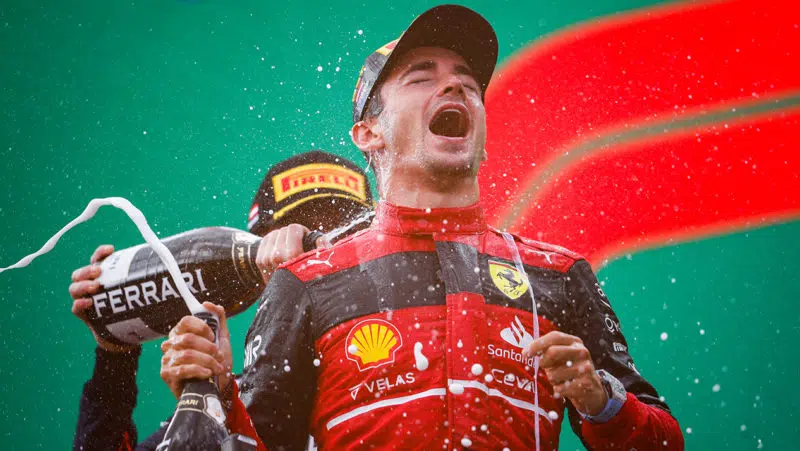 Lewis Hamilton sprays Charles Leclerc with champagne on the podium after the 2022 Austrian Grand Prix