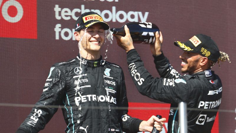 Lewis-Hamilton-sprays-champagne-over-George-Russell-on-the-podium-at-the-2022-French-Grand-Prix