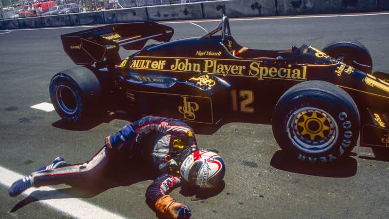 Nigel Mansell collapses trying to push his Lotus F1 car over the line at the 1984 Dallas GP