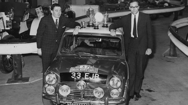 Northern Irish rally driver Paddy Hopkirk (left) and co-driver Henry Liddon (1932 - 1987) with the Mini Cooper S, in which they recently won the Monte Carlo Rally, at the Racing Car Show at Olympia, London, 27th January 1964. (Photo by Keystone/Hulton Archive/Getty Images)
