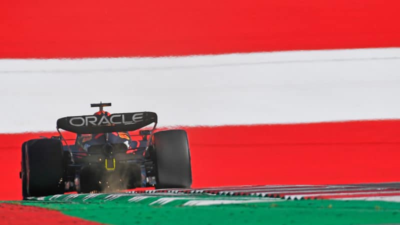 Red Bull of Max Verstappen surrounded by the red and white colours of the Austrian flag