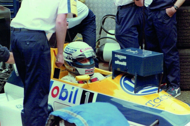 Riccardo Patrese watches a mini timing screen from the cockpit of his Williams at Monaco in 1988