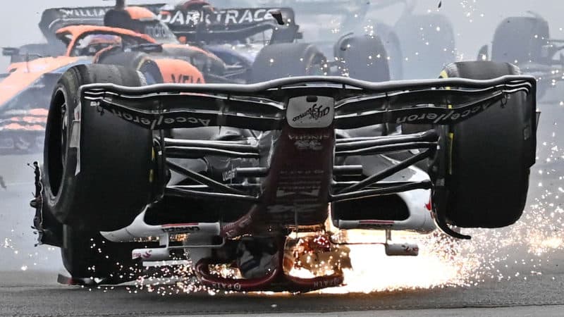 Sparks fly from the upside down Alfa Romeo of Zhou Guanyu at the start of the 2022 British Grand Prix