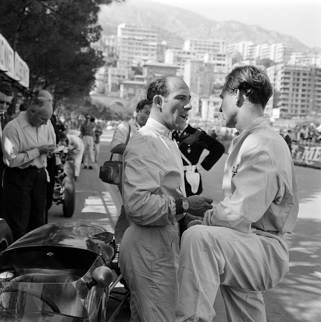 Stirling Moss and Innes Ireland compare notes at Monaco in 1960