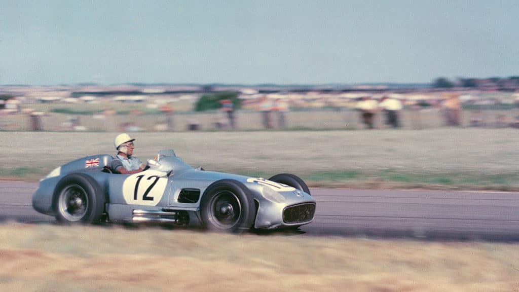 Stirling Moss guides his Mercedes-Benz at the 1955 British Grand Prix