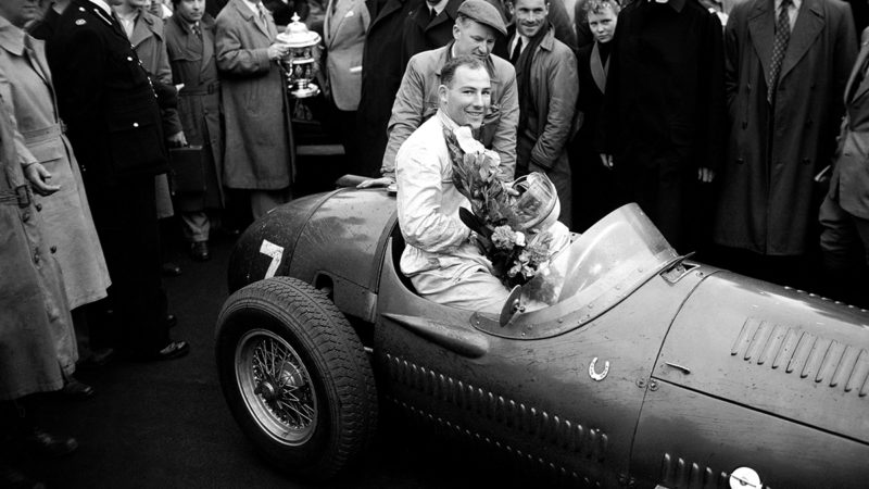 Stirling Moss sitting in his Maserati 1954