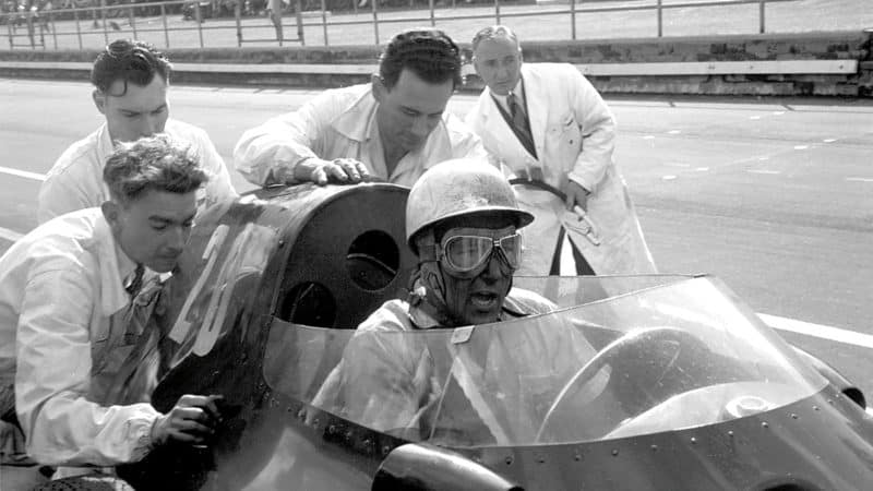 Stirling Moss with Vanwall's mechanics at Aintree, 1957