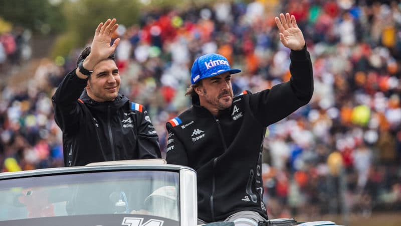Alpine F1 drivers Fernando Alonso and Esteba Ocon wave to the crowd at the 2022 Hungaria GP