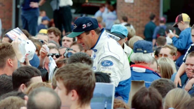 Crowds gather around Nigel Mansell at Brands Hatch in 1998