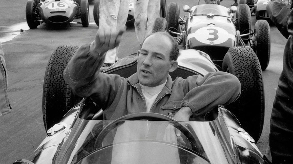 British racing driver Stirling Moss lines up with the other drivers at Silverstone racetrack