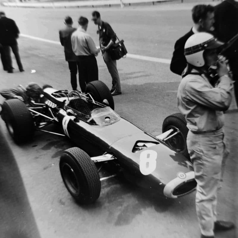 Jackie Stewart stands next to his BRM at the 1965 Belgian Grand Prix