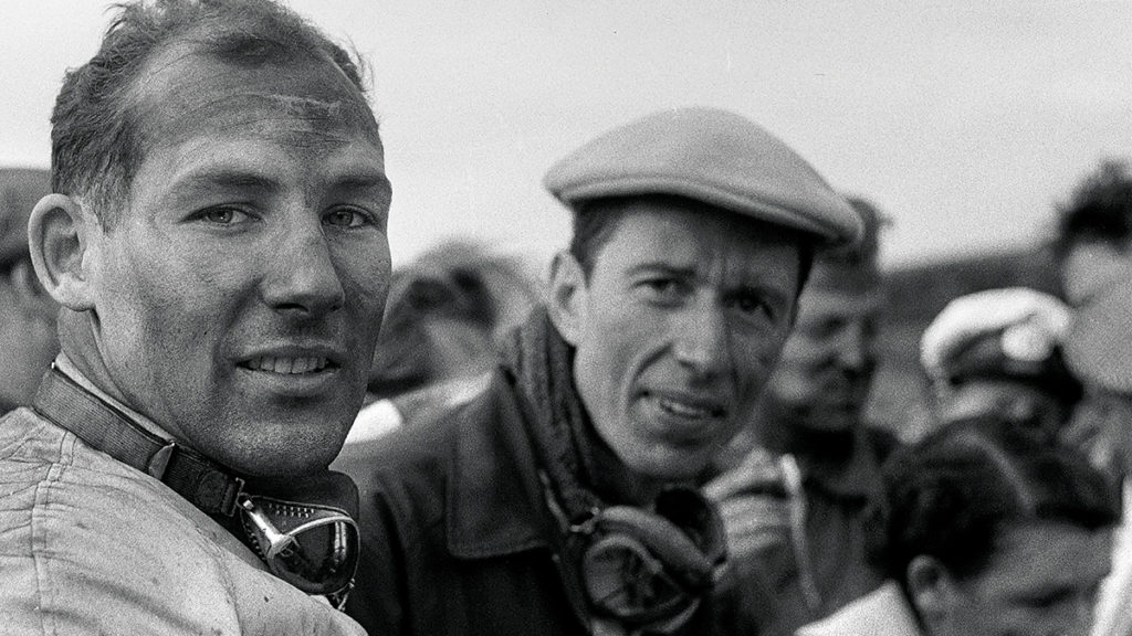 Moss at Dundrod in 1955, as co-driver John Fitch looks on