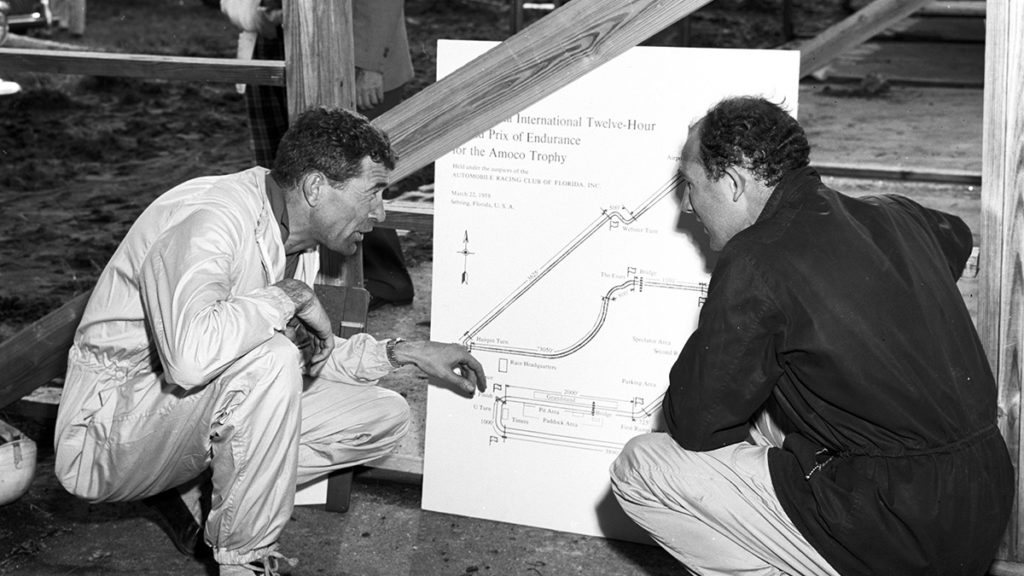 Moss chats with Aston Martin stable-mate Carroll Shelby before the 1958 Sebring 12 Hours