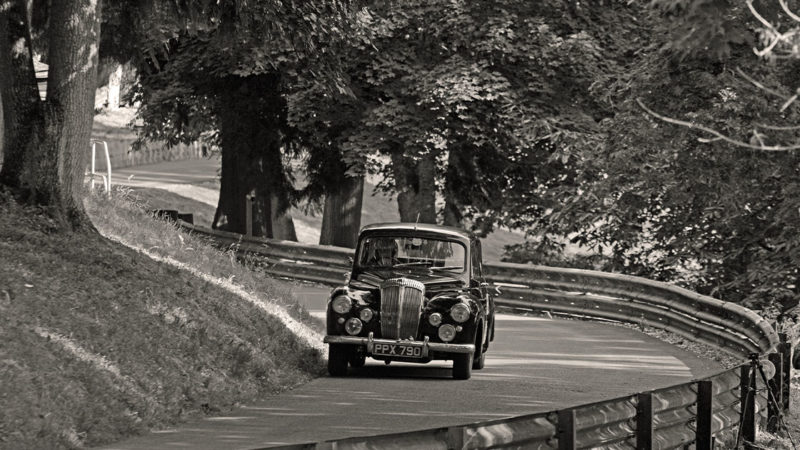 Paint it black- Peter Baker’s distinctive Daimler Conquest threads its way between the trees en route to the Prescott Esses