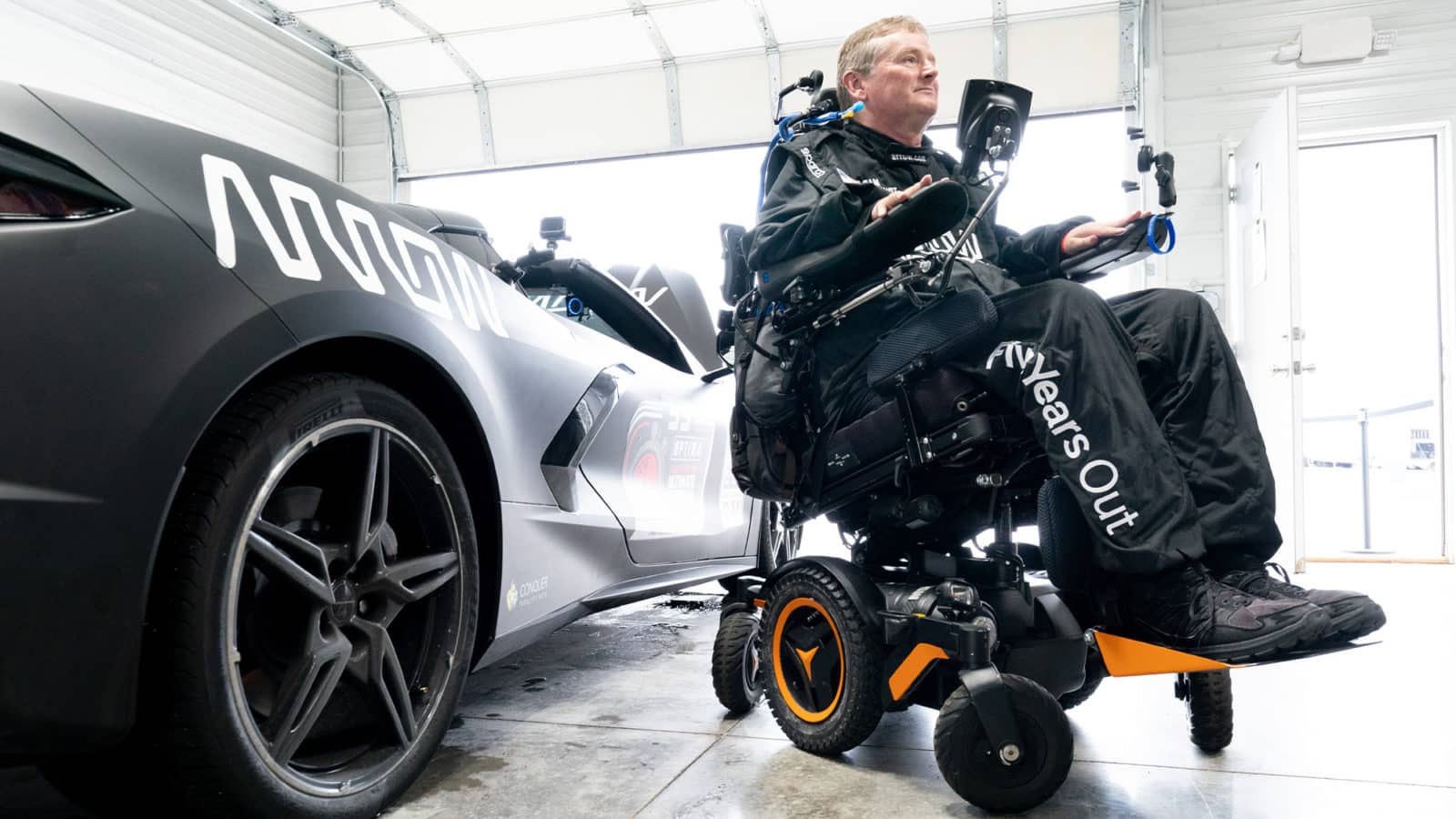 Sam Schmidt in wheelchaire next to McLaren 720S
