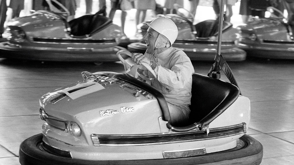 Stirling Moss tries the dodgems at Battersea Fun Fair in 1968