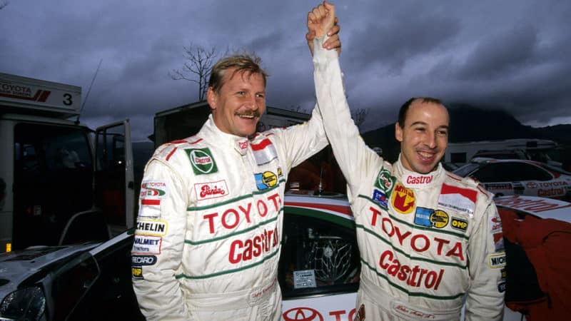 Toyota-WRC-drivers-Juha-Kankkunen-and-Didier-Auriol-celebrate-the-latter-winning-the-1994-WRC-drivers'-title