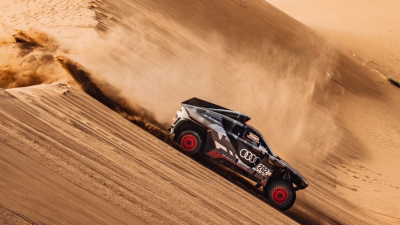 Audi car rolls down a sand dune on 2022 Dakar Rally