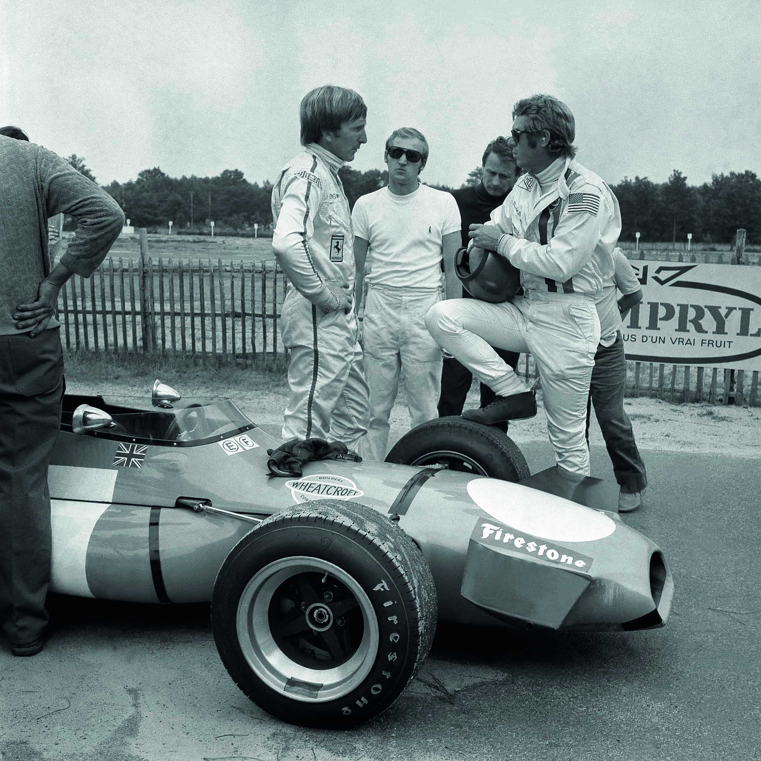 British racing driver Derek Bell (L) and