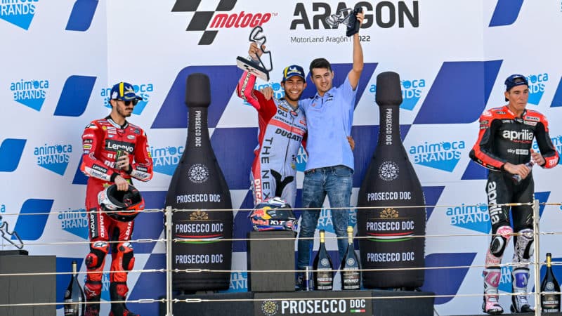 Enea Bastianini on the Aragon podium celebrating victory in the 2022 MotoGP round