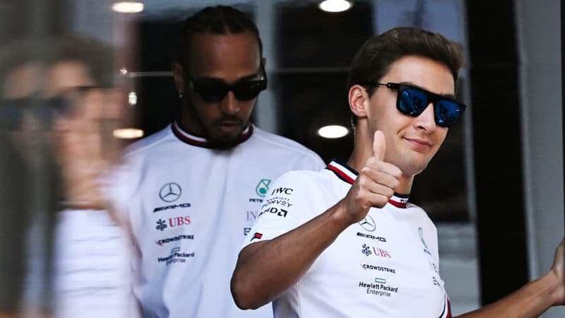 George Russell gives the thumbs up as he is followed by Lewis Hamilton