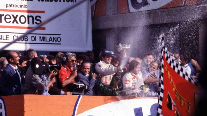 Jody Scheckter sprays champagne on the Monza podium after winning the Italian GP and 1979 championship
